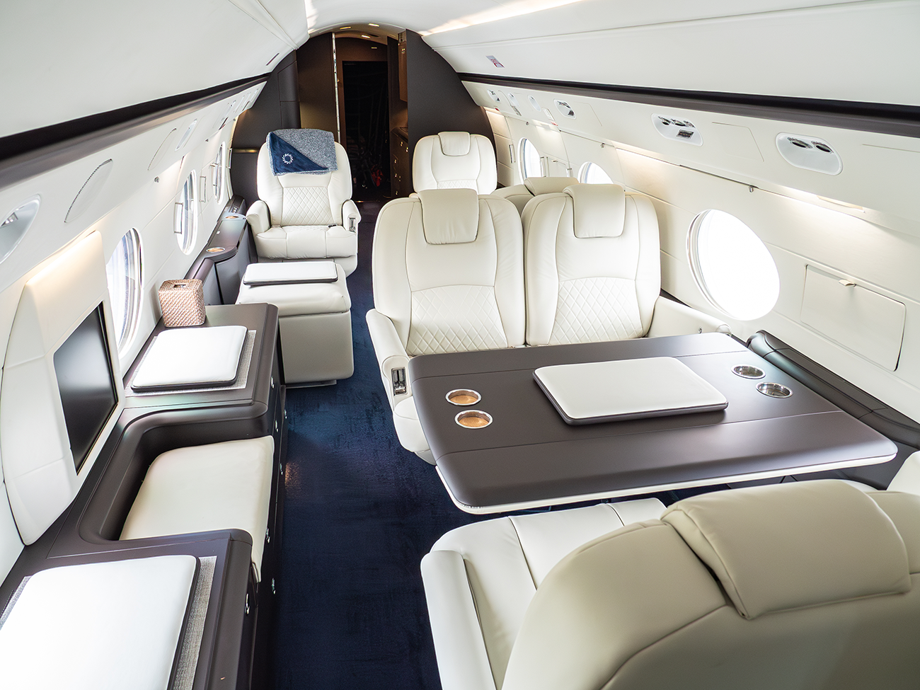 A refurbished private jet cabin with new seating and cabinetry