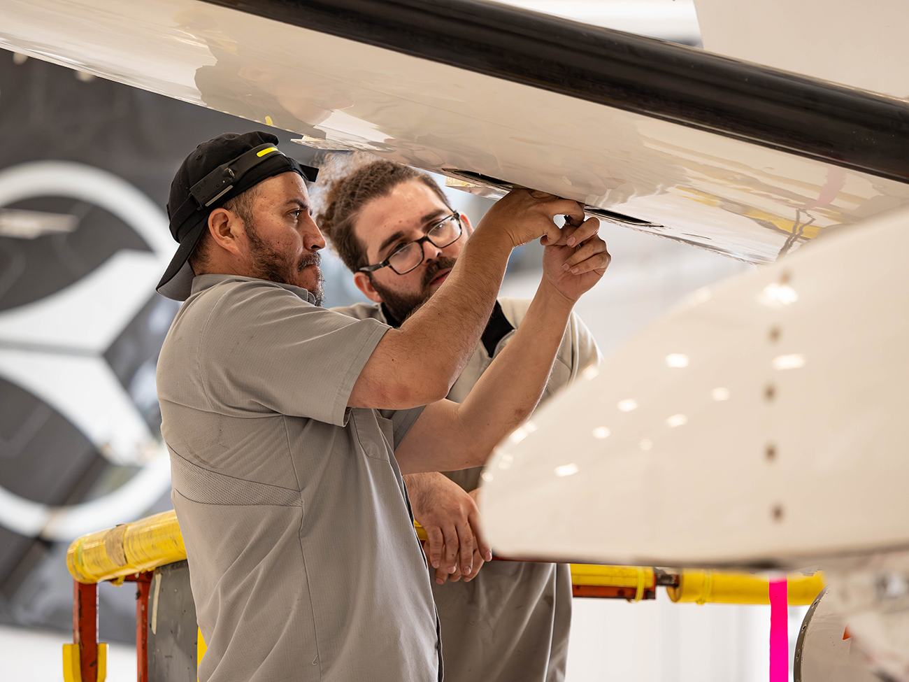 An aircraft on jacks undergoing inspection in the flyExclusive hangar