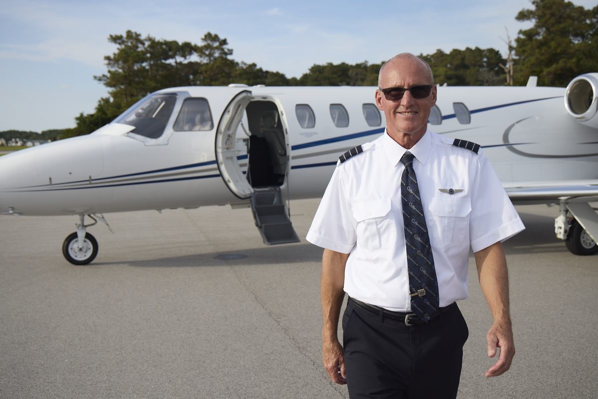 A flyExclusive captain walking from a Citation on the ramp