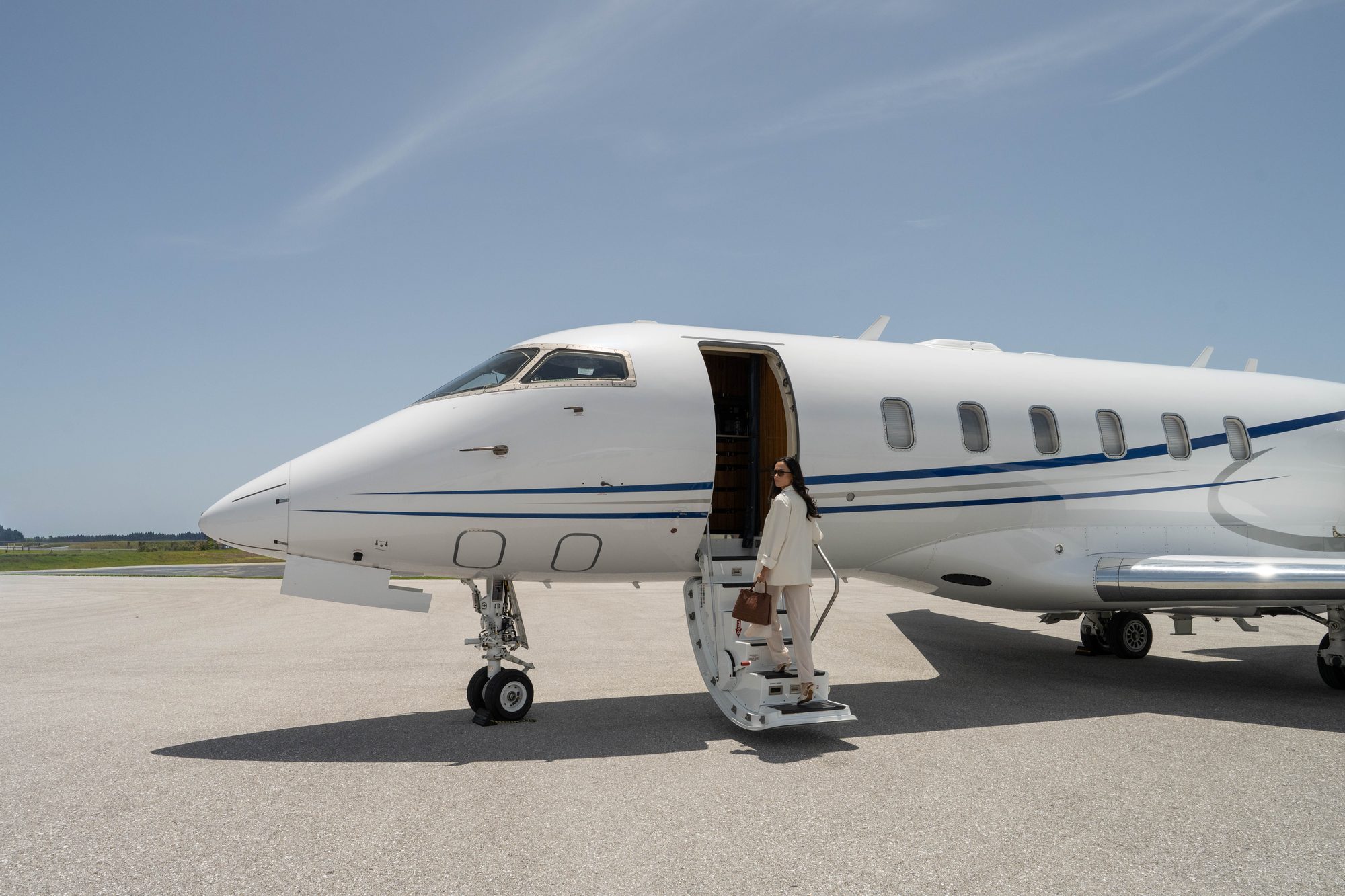 A member climbing the airstairs of a flyExclusive Challenger 350