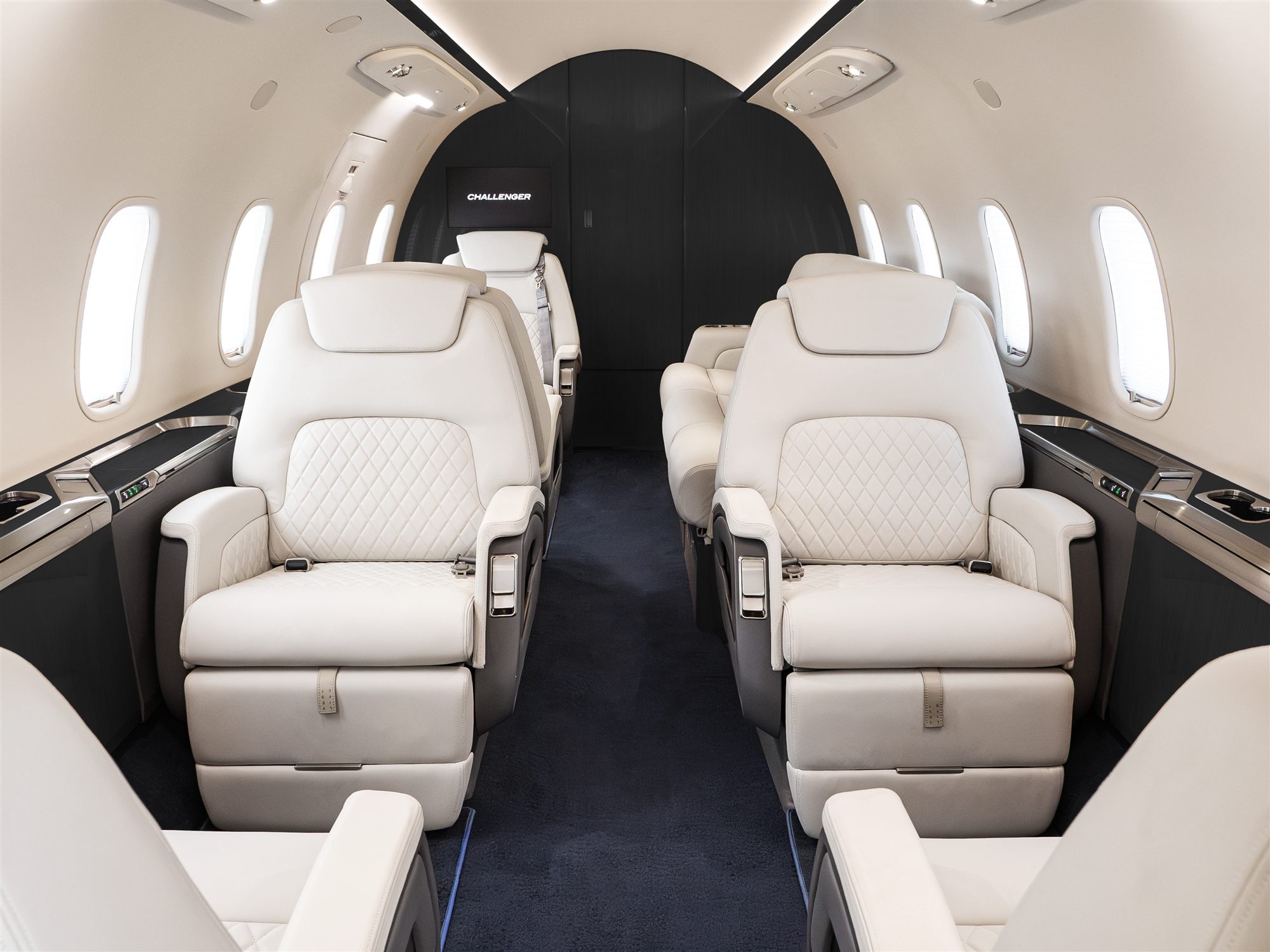 Challenger 350 cabin looking aft, four club seats in cream leather