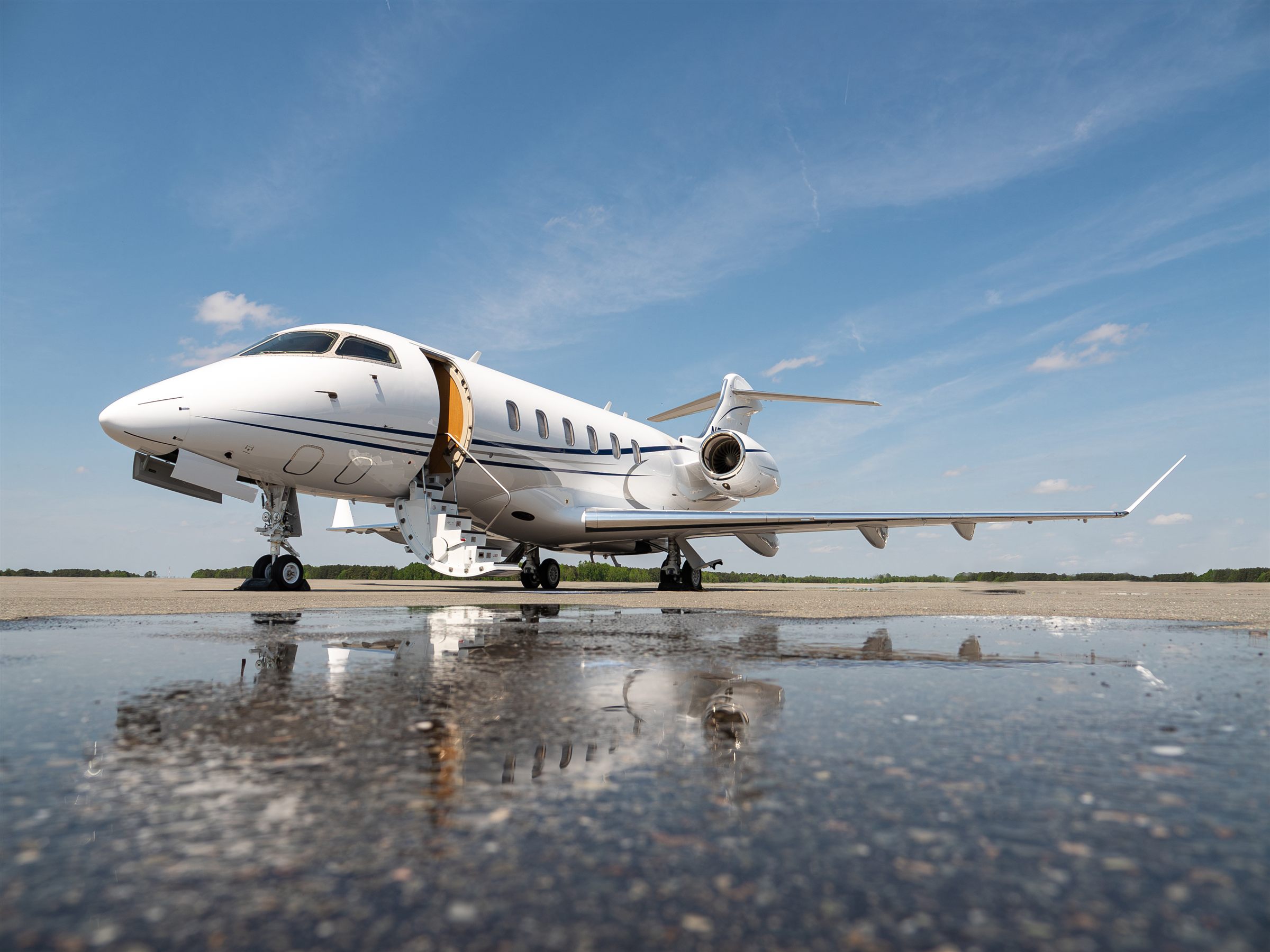 Challenger 350 mirrored on the apron outside the hangar