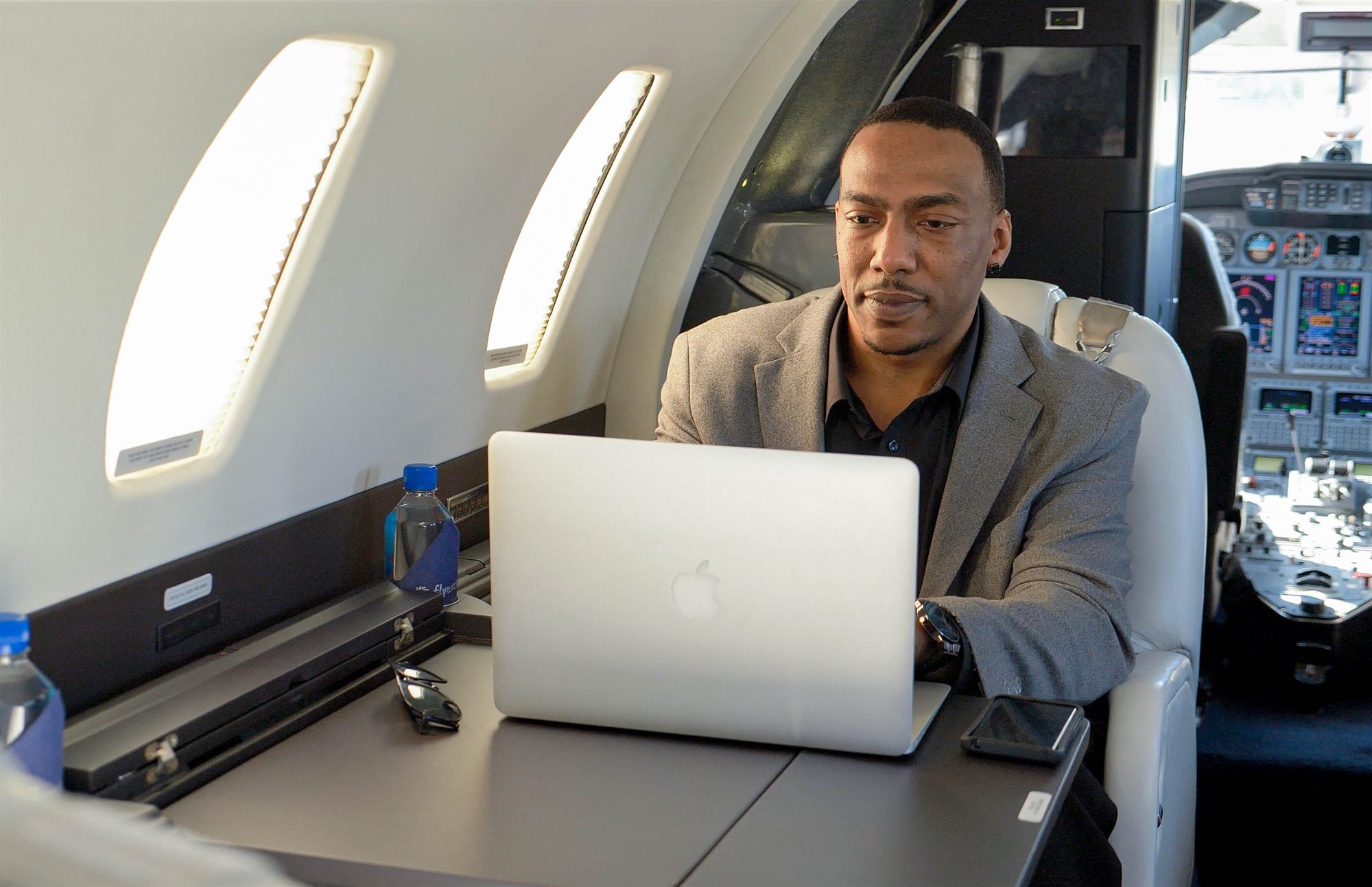Passenger working online at a cabin table in flight